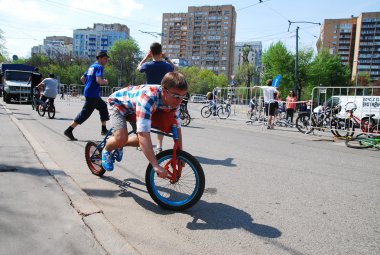 Man riding unusual  bicycle  in the center of Moscow during the festival of cycling culture in Moscow